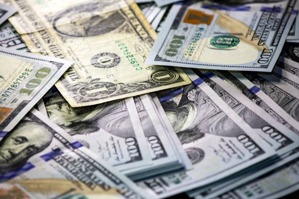 istock One dollar bill on a pack of dollars background 1192678751