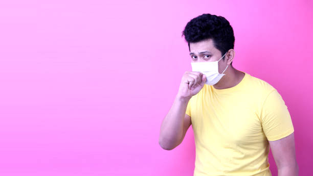 istock Asian man wearing a mask is sick  isolated on pink  background in studio With copy space. 1192682027