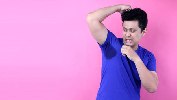 istock Asia Man sweating excessively smelling bad isolated on pink  background in studio With copy space. 1192682106