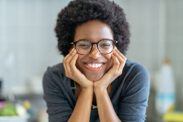 Portrait of young happy woman A close-up portrait of a young black woman while looking at camera with a beautiful smile. in the center stock pictures, royalty-free photos & images