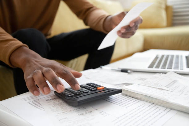 istock African American man calculating on machine accounting expenses 1192686750