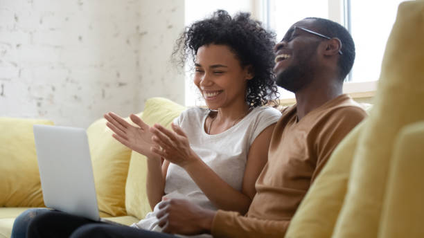istock Overjoyed african American couple have fun using laptop together 1192686755