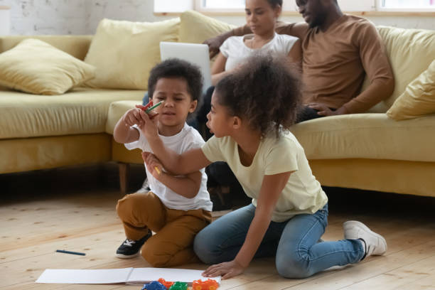 istock Small biracial kids sit on floor drawing together 1192686786