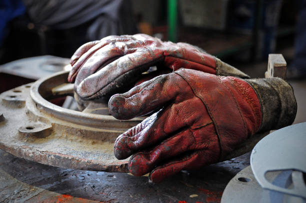 istock Old worker gloves laid down on the desk. 1192693960