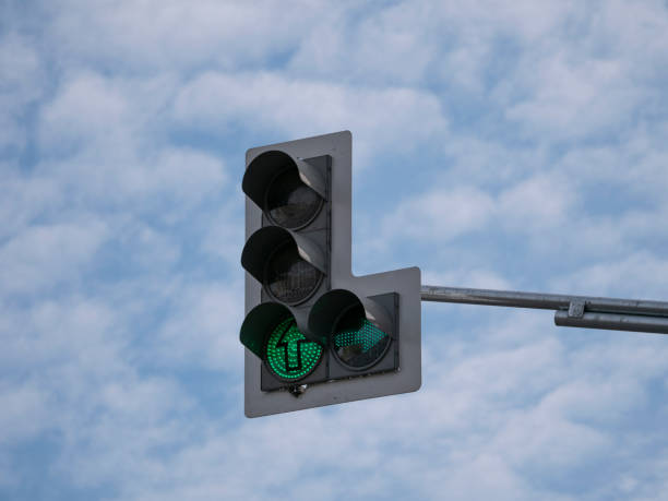 istock Green traffic light with an additional section against a cloudy sky 1192699178