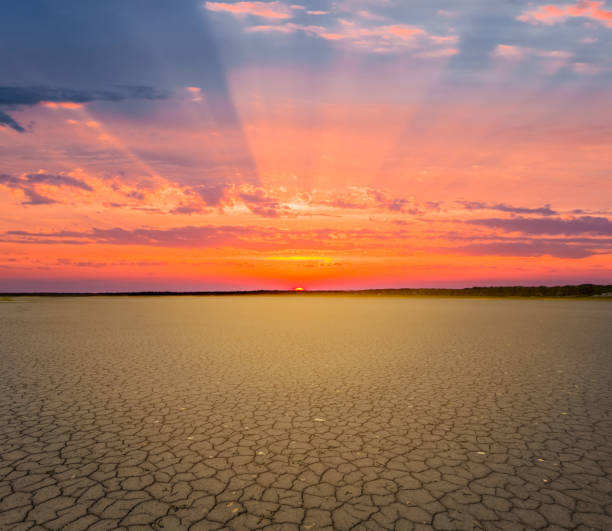 dry cracked earth at the dramatic red sunset