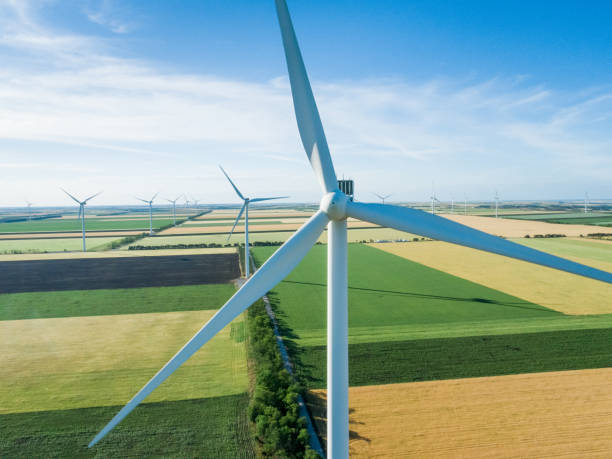 Group of windmills for electric power production in the agricultural fields. Aerial view. Group of windmills for electric power production in the agricultural fields. Aerial view. landscape alternative energy scenics farm stock pictures, royalty-free photos & images