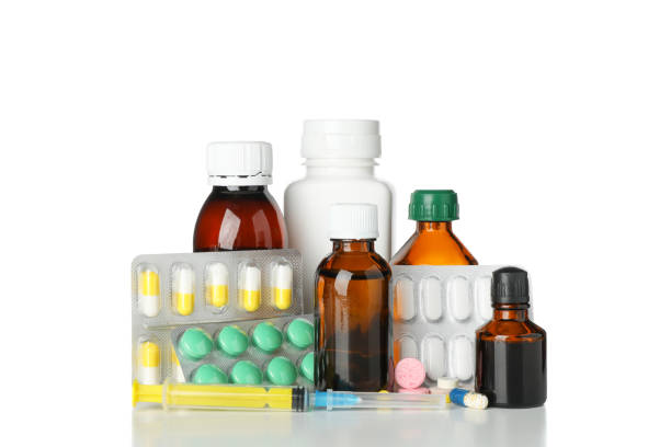 istock Medical bottles, syringe and pills isolated on white background 1192701549