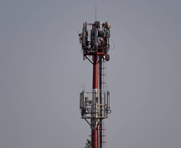 istock Telecommunication tower with antennas against with blue skyand white cloud background 1192701753
