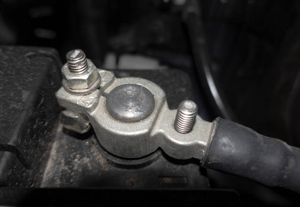 A terminal bolted to a car battery close-up.