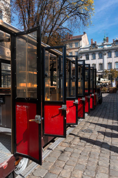 istock Row of open red and black doors on a sightseeing tram 1192707303