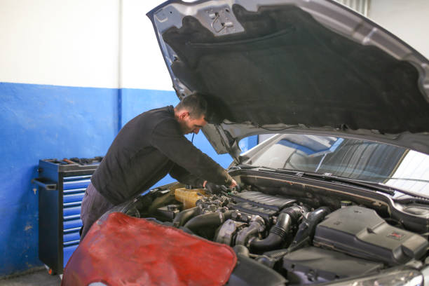 istock Young auto mechanic working in garage. Repair service. 1192709946