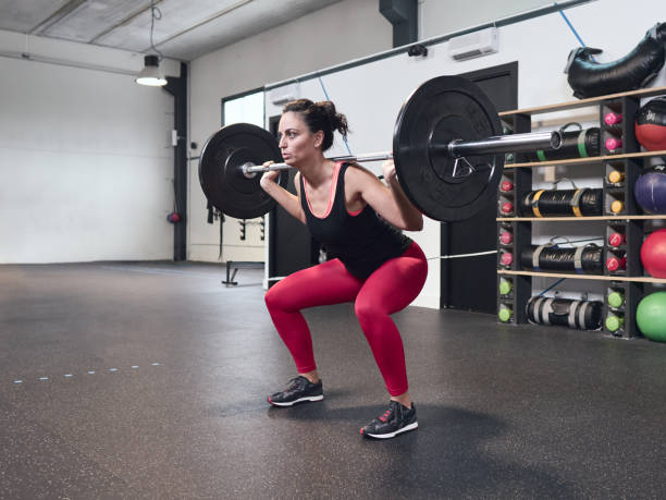 Young girl lifting weights at the high intensity interval training gym. Real training