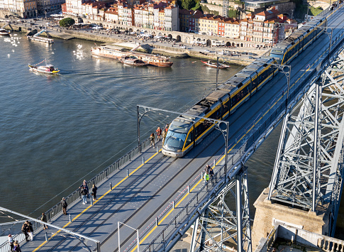 Porto, Portugal - December 03, 2019: Oporto city seen from Vila Nova de Gaia.\nWorld Travel Destination Awards prize, old buildings, Douro river and Rabelo boats. View of the D. Luis and Arrábida Bridge. Historic city monuments and Oporto wine.