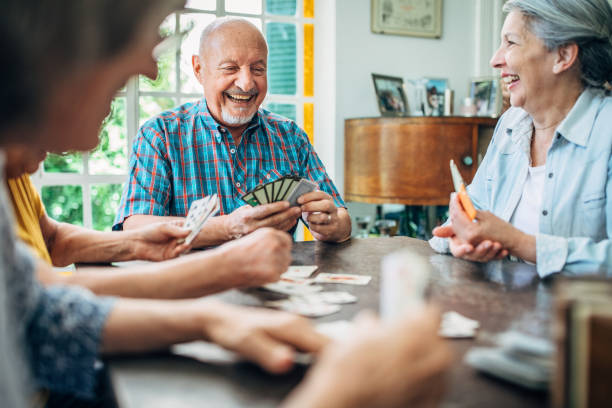 istock Group of seniors playing cards together 1192719054
