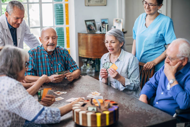 istock Group of seniors playing cards together 1192719084