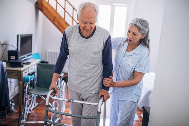 istock Senior woman supporting her husband using mobility walker at home 1192720521