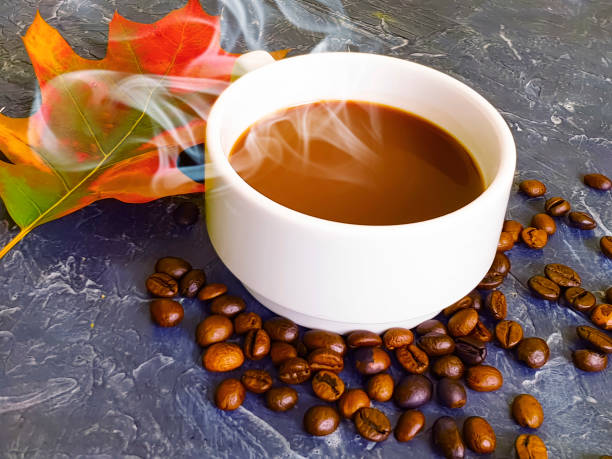 cup of coffee autumn leaf on concrete background