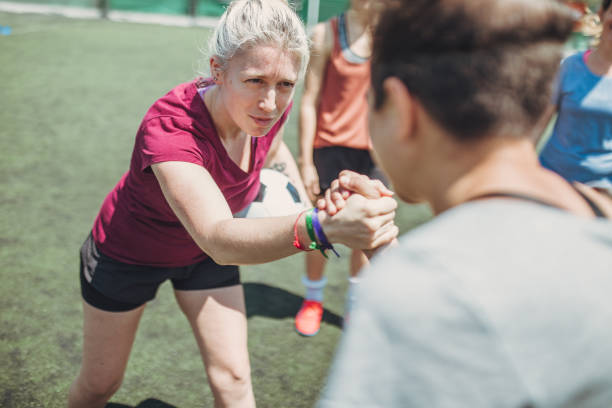 istock Women handshake on a soccer playing field 1192721670