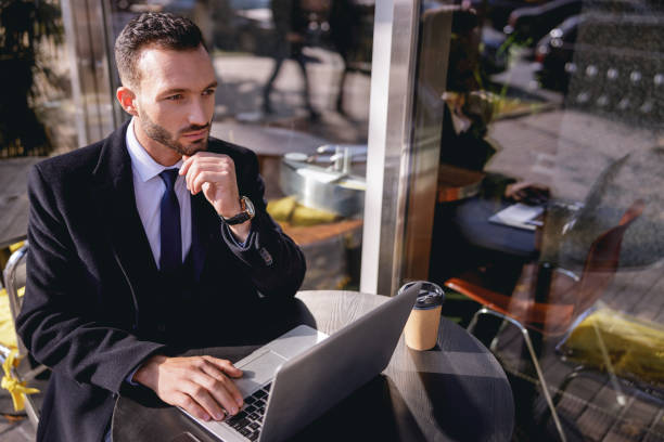 istock Handsome businessman being deep in his thoughts 1192722086