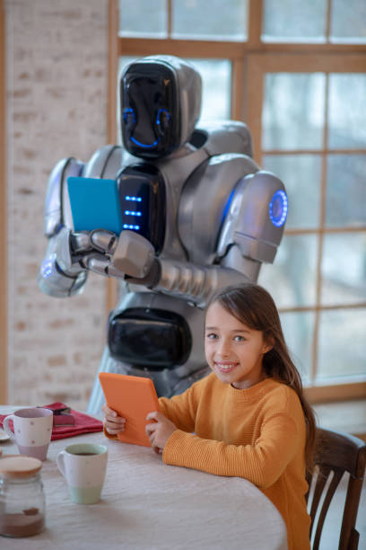 istock Robot with a tablet in his hands making pictures 1192723061