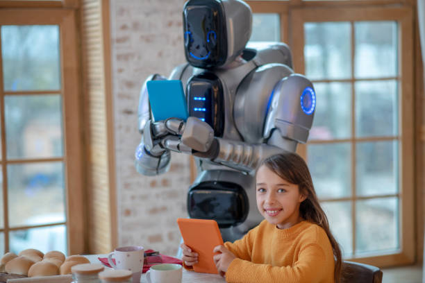 istock Robot and girl spending time together with their gadgets 1192723063