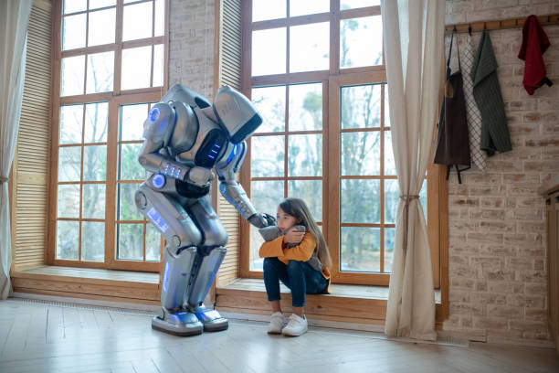 istock Robot supporting a girl touching her shoulder 1192723077