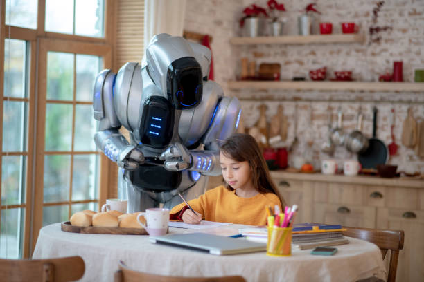 istock Robot teacher looking attentively how the girl writing 1192723162