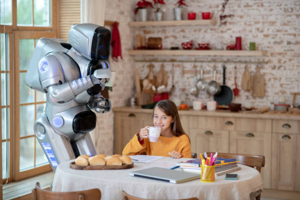 istock Smiling girl and robot having tea together 1192723169