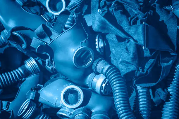 Photo of Blue toned background of vintage gas respirator masks