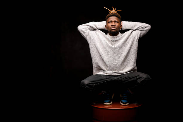 istock African american guy squatting on a barrel 1192728549
