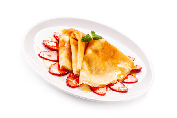 istock Crepes with strawberries and cream on white background 1192728554