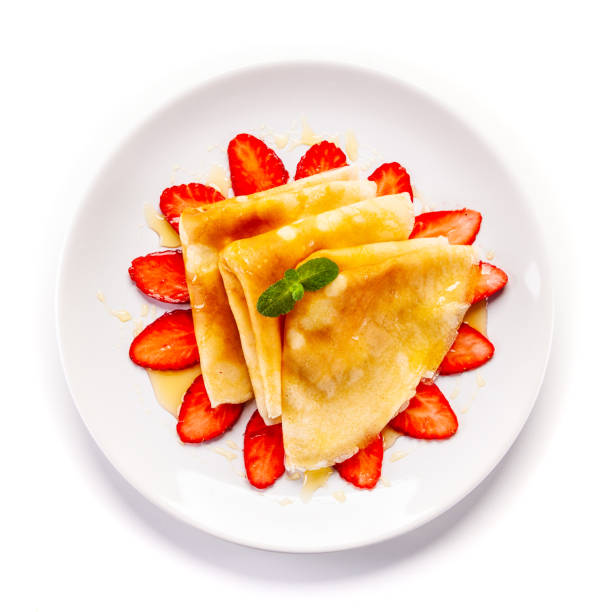istock Crepes with strawberries and cream on white background 1192728634