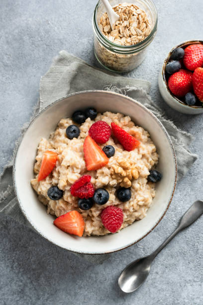 Bowl of oatmeal porridge with fresh berries top view stock photo