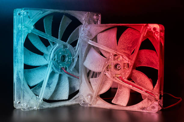 istock Two computer fans are covered with a thick layer of dust on a dark background in the light of bright spotlights. The concept of dirt, damage to equipment, a need for preventive maintenance. Close-up 1192729445