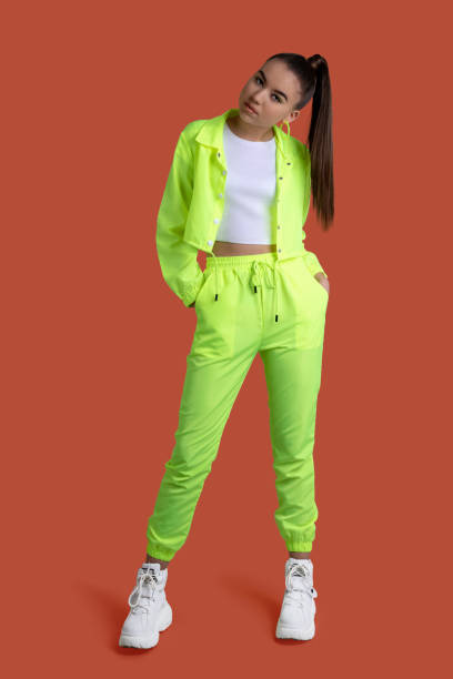 Girl In A Yellow Neon Tracksuit On A Colored Background Stock Photo -  Download Image Now - iStock