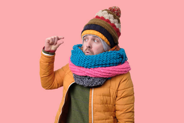 istock Handsome caucasian funny man in several hats and scarfs. 1192730784
