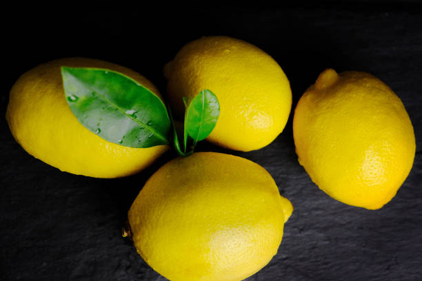 istock Fresh yellow lemons with green leaves. 1192731120