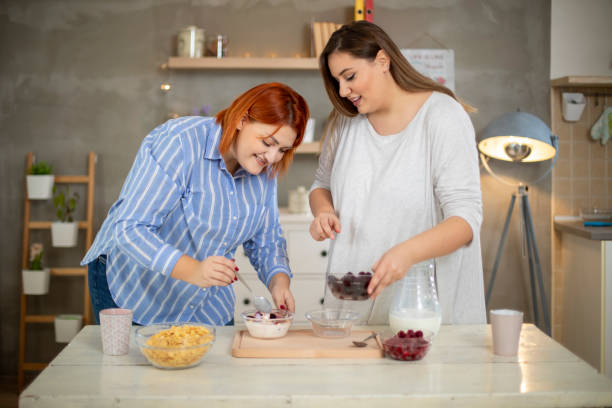 istock Young smiling plus size women preparing breakfast. 1192732237