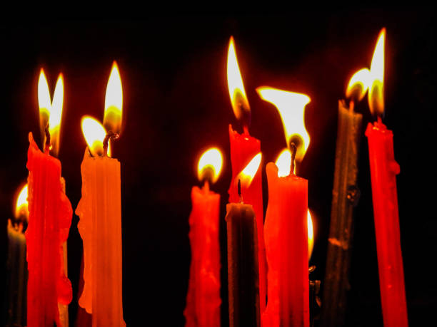 istock Burning red and yellow candles 1192733099