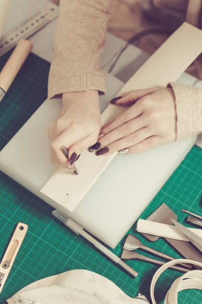 istock Woman hands creating leather handbag in a workshop 1192733165