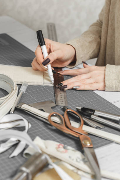 istock Woman hands creating leather handbag in a workshop 1192733508