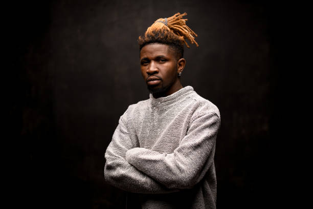 istock Black man with blonde dreadlocks posing with crossed arms 1192735601