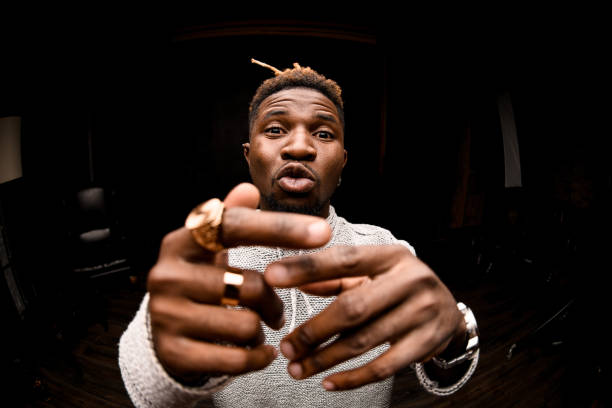 istock Fish-eye photo black man with blonde dreadlocks posing looking at camera talking something 1192736252