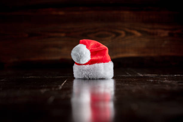 istock Santa Claus hat on wooden table and background 1192737416