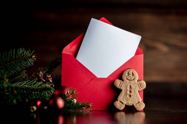 istock Gingerbread man and Christmas tree with red envelope 1192737425