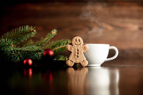 istock Cup of coffee and gingerbread man cookie 1192737456