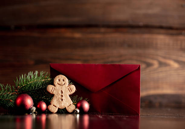 istock Gingerbread man and Christmas tree with red envelope 1192737532