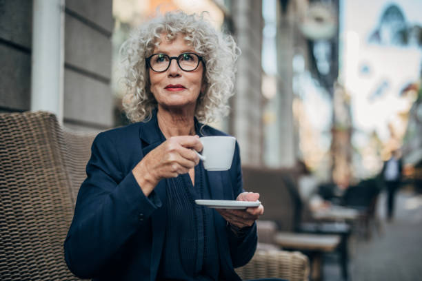 istock Beautiful senior woman drinking a hot drink 1192739032