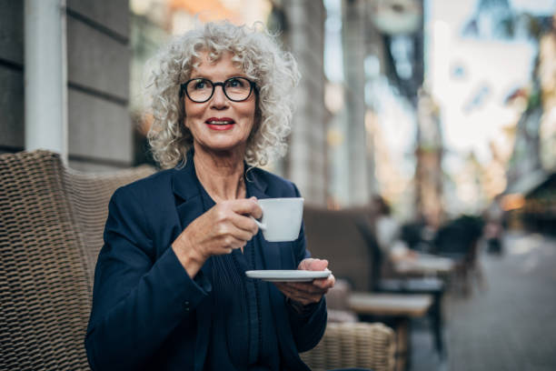 istock Beautiful senior woman drinking a hot drink 1192739068